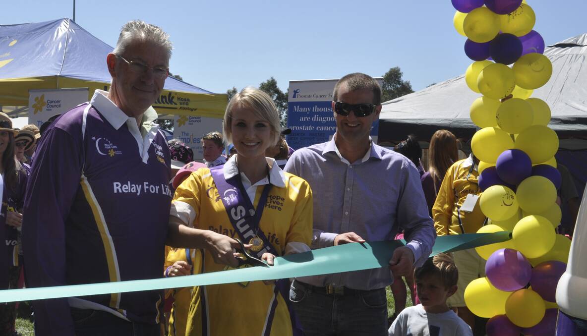 CESSNOCK RELAY FOR LIFE 2013: Nell Thompson cuts the ribbon with Mayor of Cessnock, Cr. Bob Pynsent and Relay patron, Member for Cessnock Clayton Barr. Photo: The Advertiser.