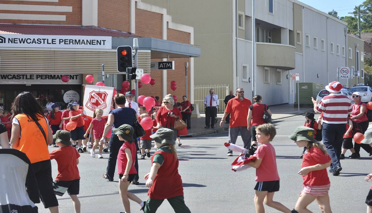 Students and teachers dressed in red takeover the main streets of Cessnock. 