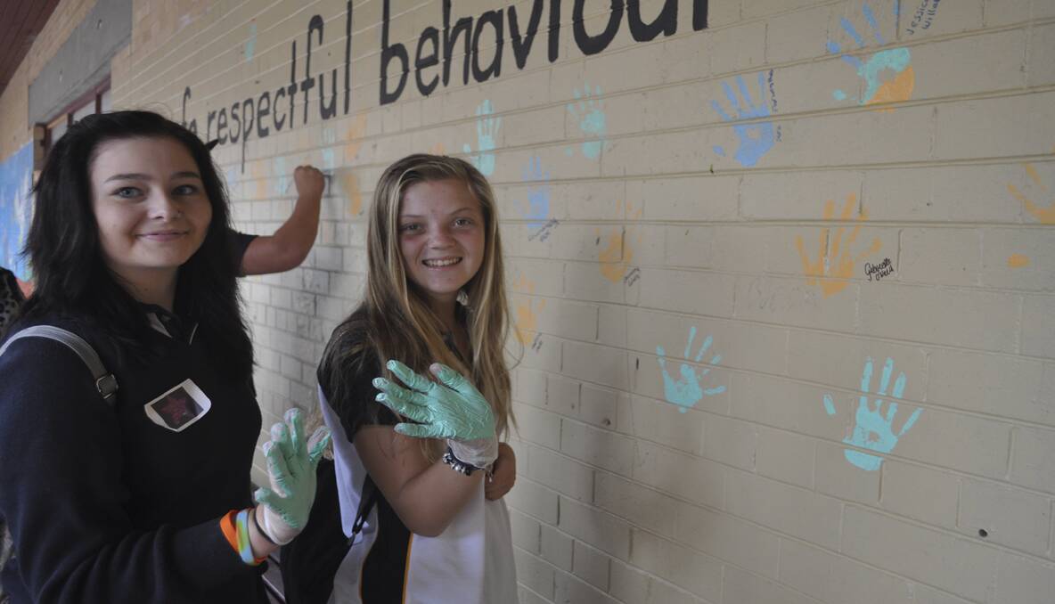 PLEDGE: Justice Ward and Jade Earl add their handprints to the ‘wall of commitment’. 