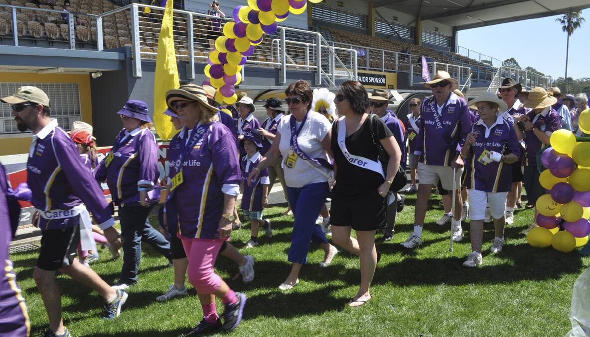 CESSNOCK RELAY FOR LIFE 2013: Cancer survivors and carers walk the opening lap. Photo: The Advertiser.