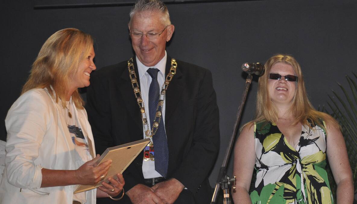 Cherin McNamara collects her mother Merle Pullar's Australia Day appreciation award from Cessnock Mayor Bob Pynsent and ambassador Krystel Keller.