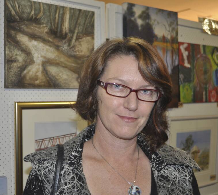 Artist Cindy Staley and her piece 'Walking along Weston Creek’ (top left), winner of the Scenes from Weston special award. 