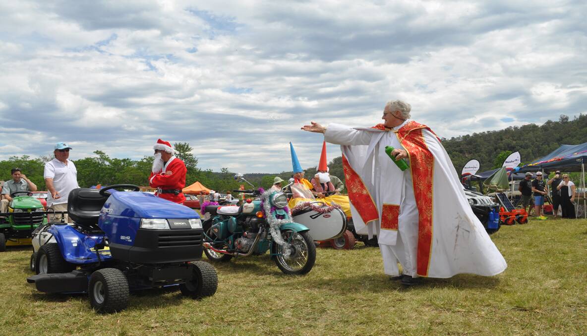 Fr. Graham Jackson blesses the mowers that took part in the Mower Mardi Gras.