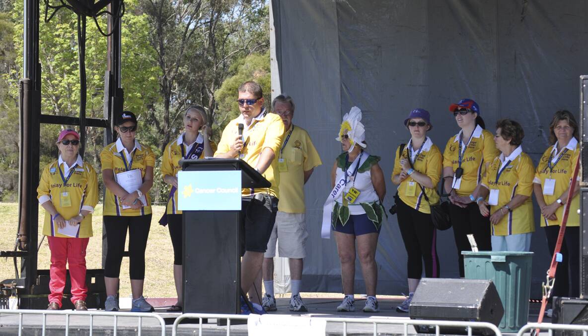 CESSNOCK RELAY FOR LIFE 2013: Chairman Ben Woolley and committee members on stage at Cessnock Relay For Life. Photo: The Advertiser.