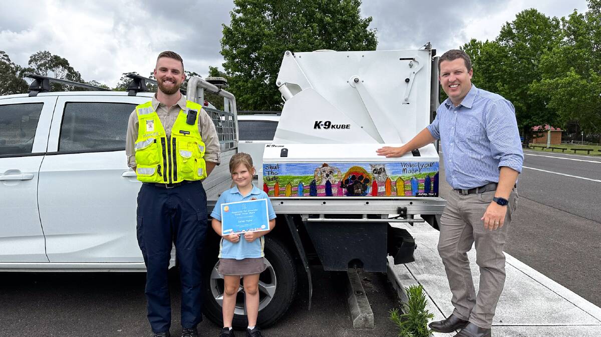 A winning design of Ashley Taylors displayed on a council vehicle with council ranger Ryan and Cessnock Mayor Jay Suvaal. 