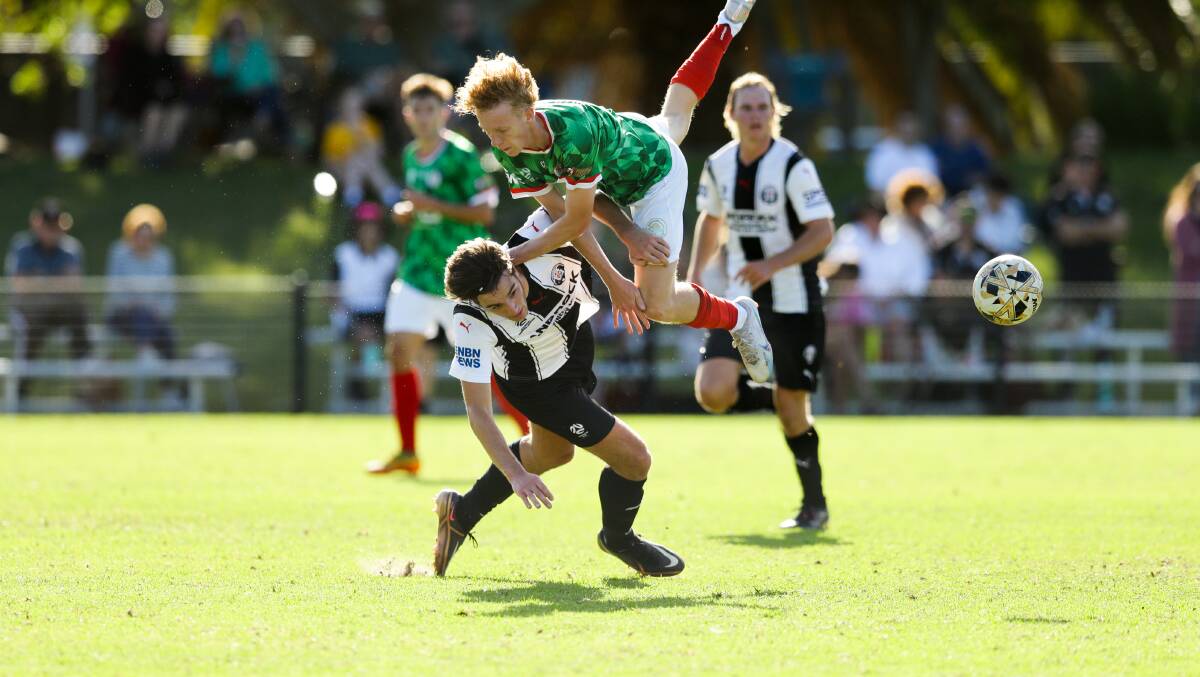 Bears' player Alessandro Ouwerkerk (left) in a challenge with Rosebuds' Murray Peart during the NNSW NPL match between Adamstown and Weston Workers on Tuesday, April 25. Picture by Jonathan Carroll 