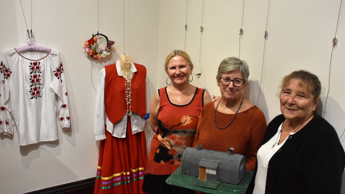 EXHIBIT: Elizabeth Matt, who grew up in the Greta Migrant Camp, with Maitland Regional Museum president Janece McDonald and Pam Graham. An exhibit marking the anniversary of the site will open on Saturday.