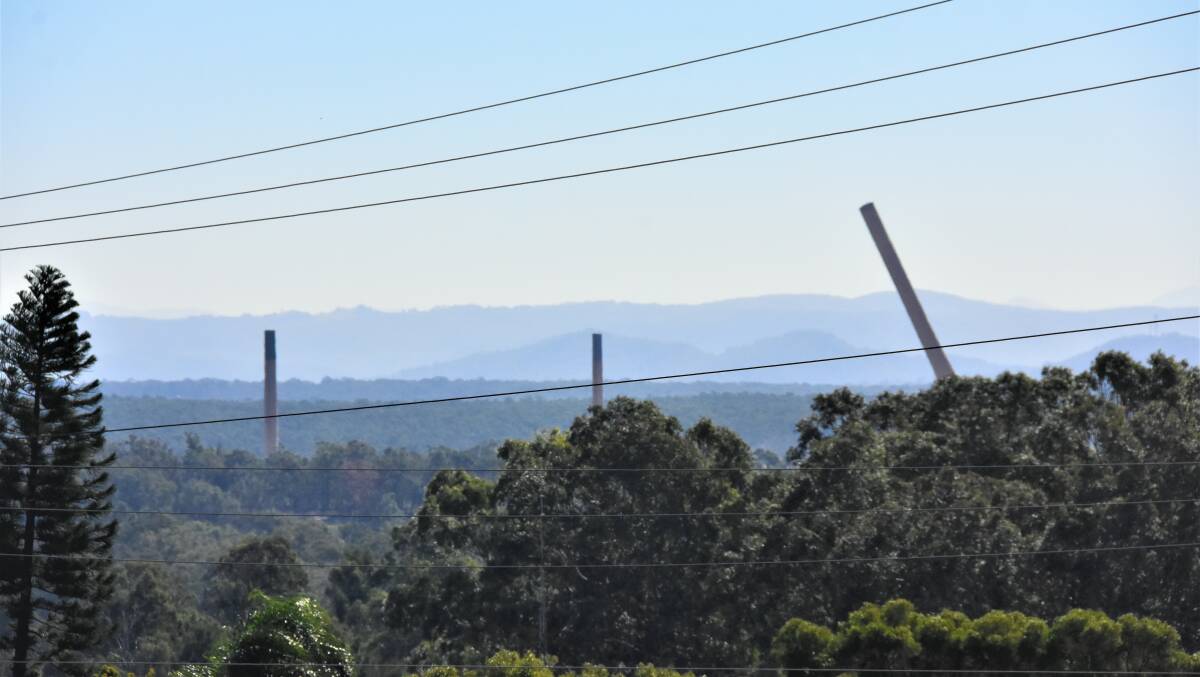 EXPLOSION: The three iconic stacks and main water tower were demolished at the site of the former Kurri Kurri smelter on Thursday as part of a major redevelopment project.