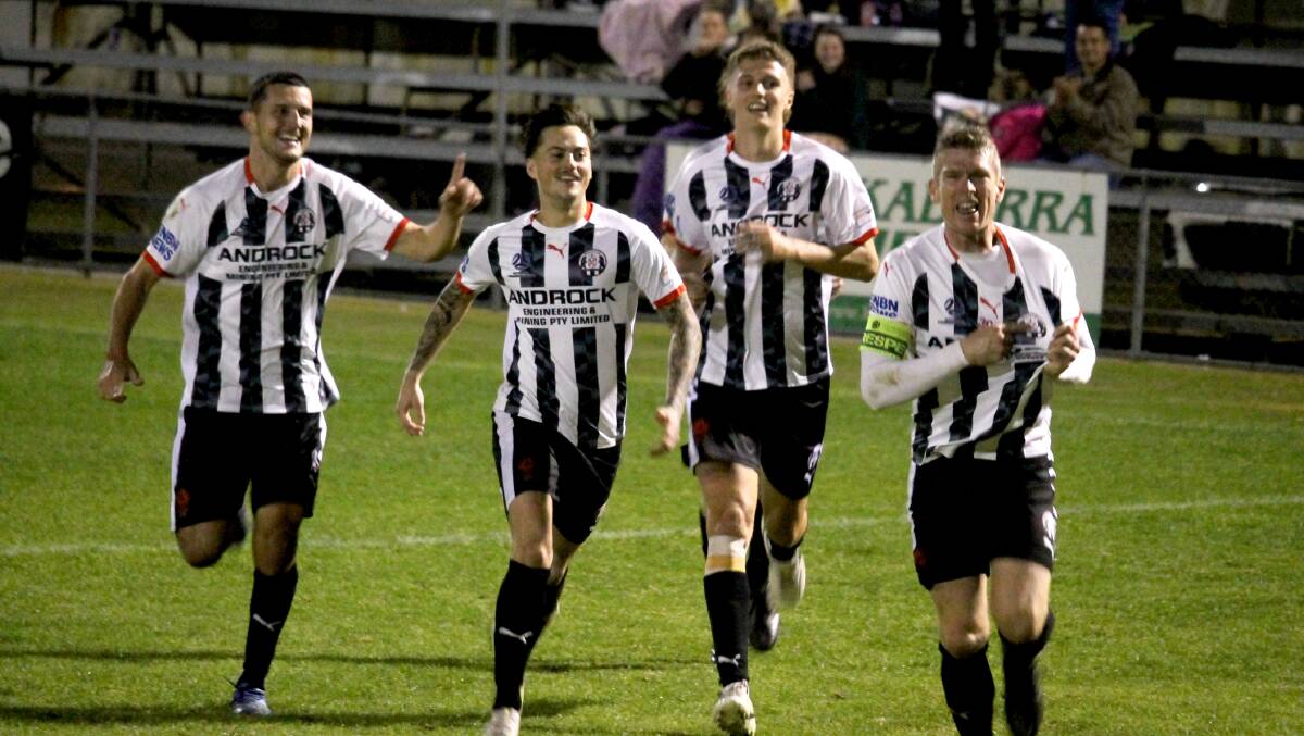 PROUD BEAR: Nathan Morris (right) celebrates after slotting home the winner from the penalty spot in his 300th game for the Weston Bears.