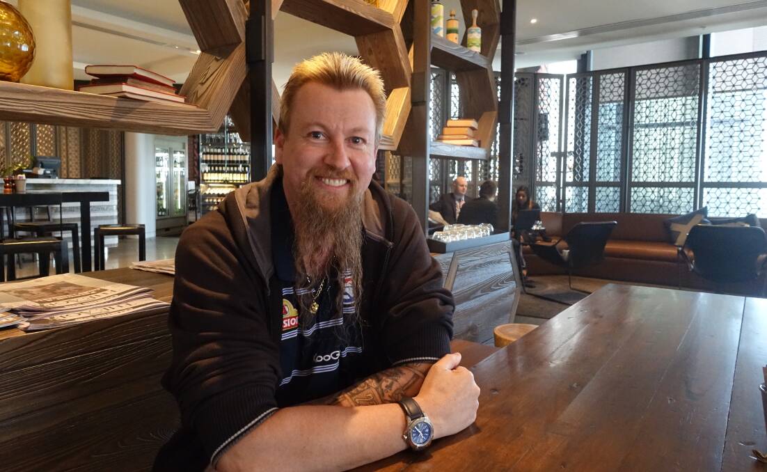 WINNING SMILE: Aussie darts champion Simon Whitlock relaxes over coffee before the Melbourne Darts Masters. Picture: Michael Hartshorn