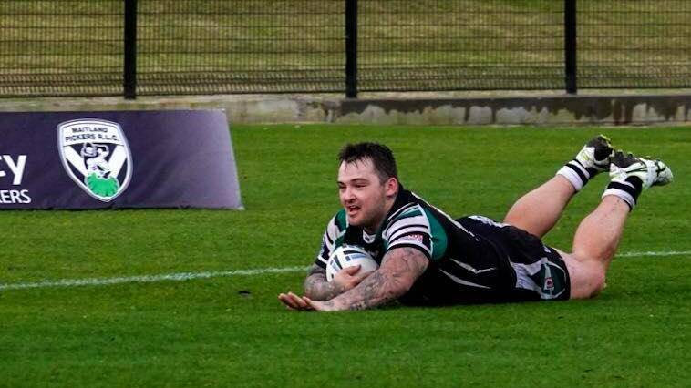 Tylar Carter slides in for a try in his 100th game.