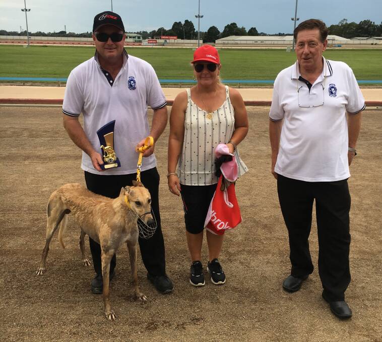 
TROPHY WIN: Maitland Greyhounds director Gary Minter presents the Newcastle GBOTA Branch Xmas Sprint Final trophy to Michael and Jodie Manuel and Swizzle Sticka.