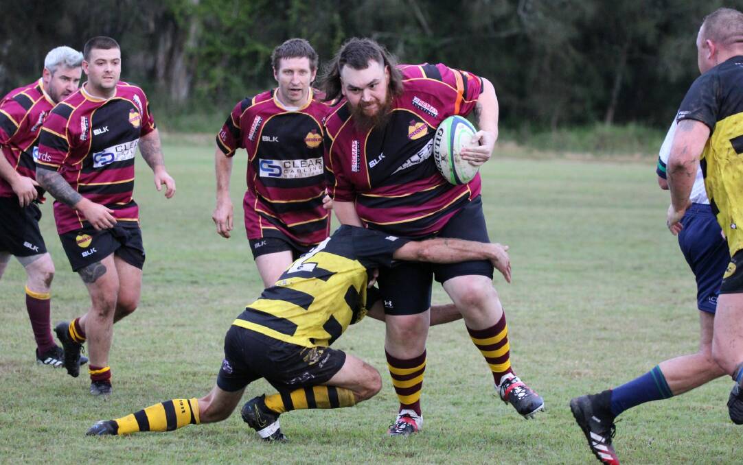 COMING THROUGH: Reds forward Edward Weaver attempts to bust through the Cessnock Mongrels line. Picture: Melissa Meyers
