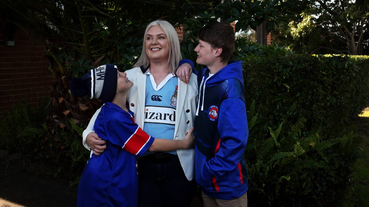 MUM ON A MISSION: Amanda Barrass, pictured with sons Evan, 12, and Rhys, 13, says singing the national anthem at the State of Origin in Newcastle would create a special memory for her sons. Picture: Simone De Peak