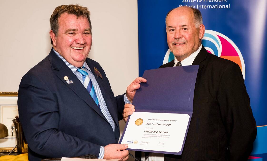 HONOUR: District Governor Elect Brian Coffey presents outgoing Cessnock Rotary Club president Graham Farish with his Paul Harris Fellow award. Picture: George Koncz