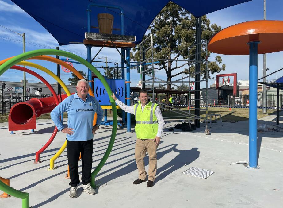 Senior pool attendant Terry Fernie and Cessnock mayor Jay Suvaal check out the progress of the splash pad project at Cessnock Pool. Picture by Krystal Sellars.