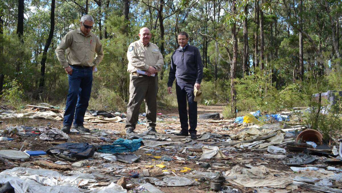 DISGRACE: Department of Primary Industries – Lands Hunter group leader Rob Micheli, Regional Illegal Dumping Squad project coordinator Rob Robertson and Parliamentary Secretary for the Hunter Scot Macdonald inspect an illegal dumping site near Kurri Kurri. Picture: KRYSTAL SELLARS