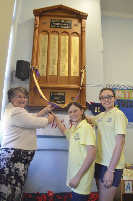 SPECIAL OCCASION: Member for Paterson Meryl Swanson unveils the replica World War I honour roll with Kurri Kurri Public School captains Bailey Parker and Zoe Barbour on Friday. Picture: Krystal Sellars
