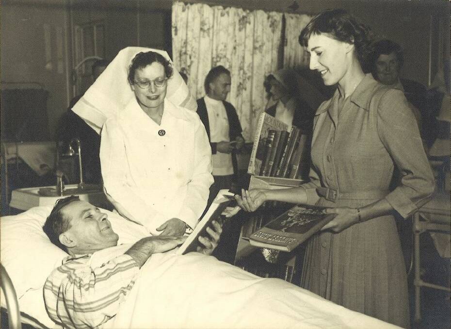 Pat Vile, Cessnock's first Librarian, at Cessnock Hospital in 1955. The library had an books-to-beds program in conjunction with the hospital and Cessnock Lions Club.
