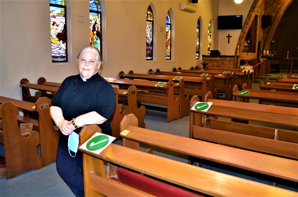 STAY SAFE: Reverend Robin Lewis-Quinn at St John's Anglican Church, Cessnock, where social distancing markers are placed on the pews. Picture: Krystal Sellars