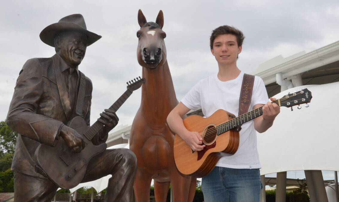 FLASHBACK: Finnian Johnson, pictured with the Reg Lindsay statue after winning the talent quest at East Cessnock Bowling Club in 2017. Picture: Krystal Sellars