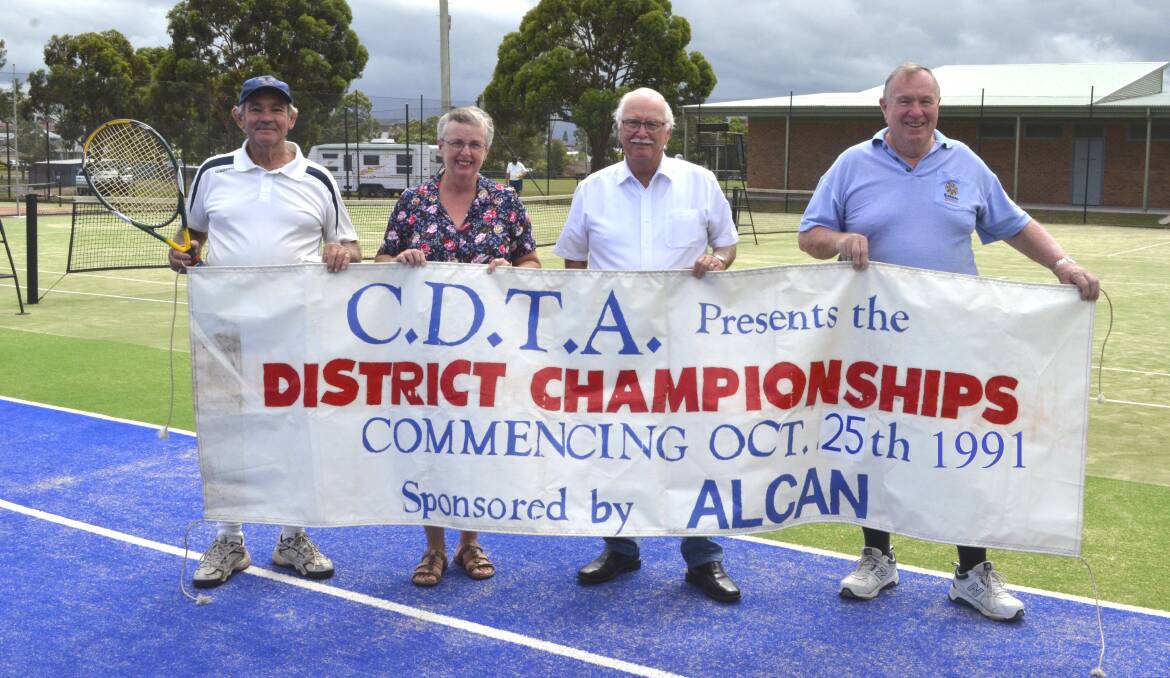 MEMORIES: Col Andrews, Christine Paterson, Rod Doherty and Les Odd with the banner from the Alcan Championships, one of the biggest events in Kurri tennis history.