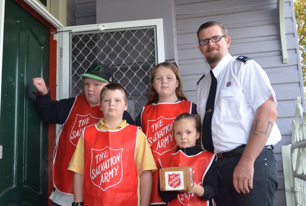 DOOR KNOCK: Baldrick, Seth, Stephanie, Hazel and Brett Dunlop will be among the volunteers collecting for the Salvation Army in Cessnock on May 26 and 27.