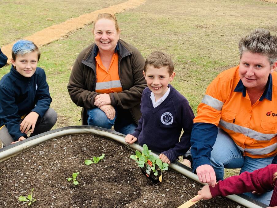 GREEN THUMBS: Millfield Public School students Hunter and Corey with Austar Coal Mine representatives Julie McNaughton and Carly McCormack enjoying the new community garden.