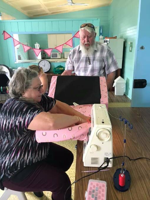 MEN WELCOME TOO: Keren Nelson and John Gittoes working the sewing machine at the Women's Shed Branxton.