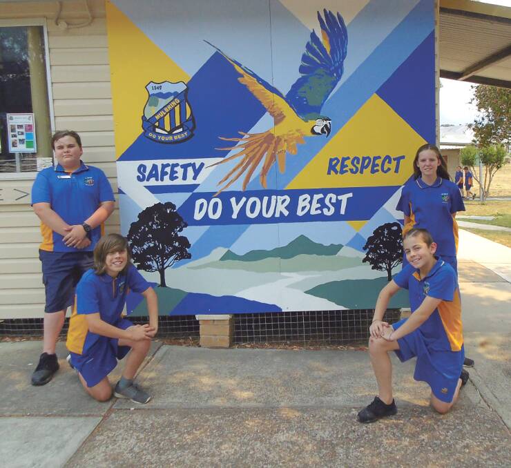 PROUD: Mulbring Public School year 6 students Elijah, Jake, Kai and Vanessa in front of the mural they created in conjunction with Kurri Kurri High School. 