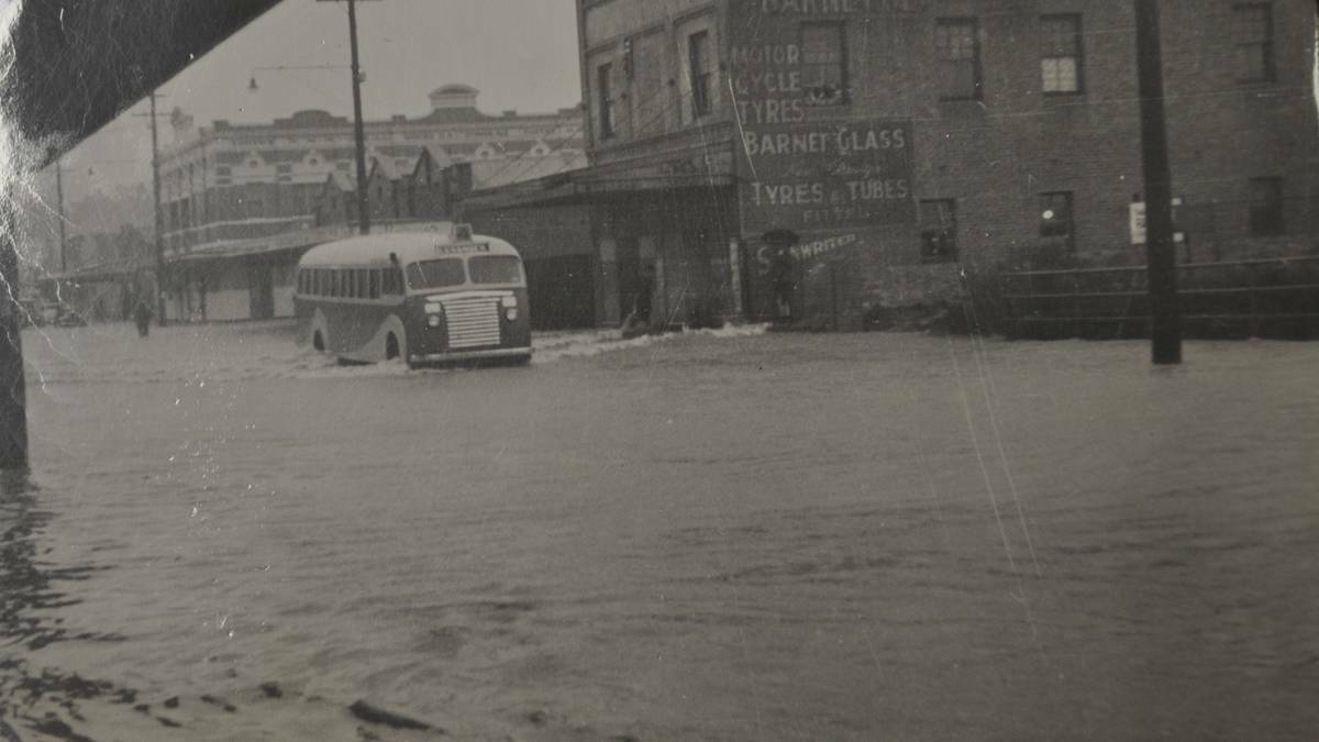 DECADES-LONG PROBLEM: A bus drives down southern Vincent Street during the 1949 flood, with the Royal Oak Hotel in the background.