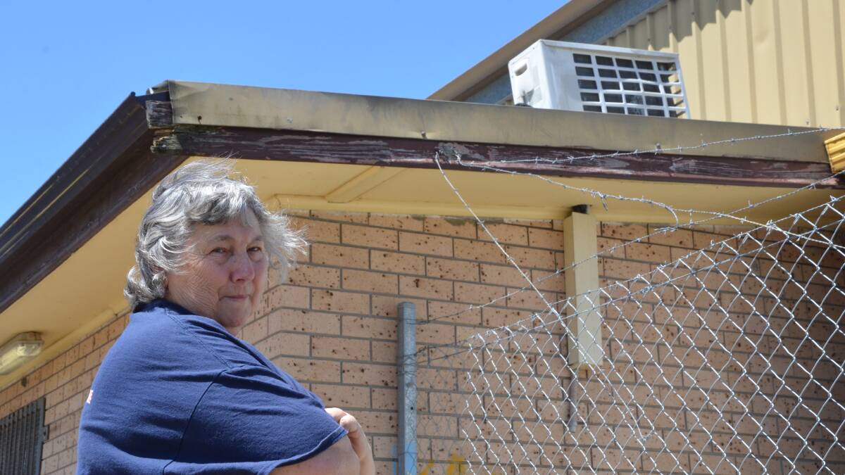 RUDE SHOCK: Central Rural Fire Brigade senior deputy captain Veronica Bullen and the air-conditioner that was damaged by vandals over the weekend. Picture: Krystal Sellars