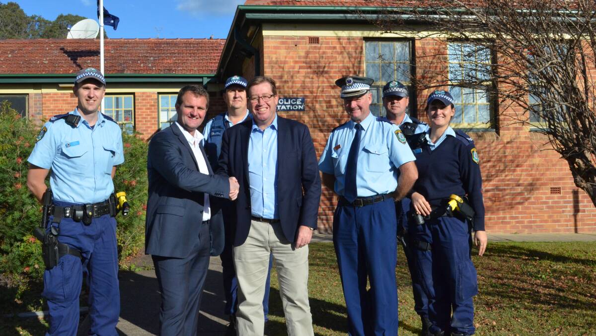 BIG WIN: Cessnock MP Clayton Barr and NSW Police Minister Troy Grant celebrate the announcement with local officers at Cessnock Police Station on Saturday. Picture: Krystal Sellars