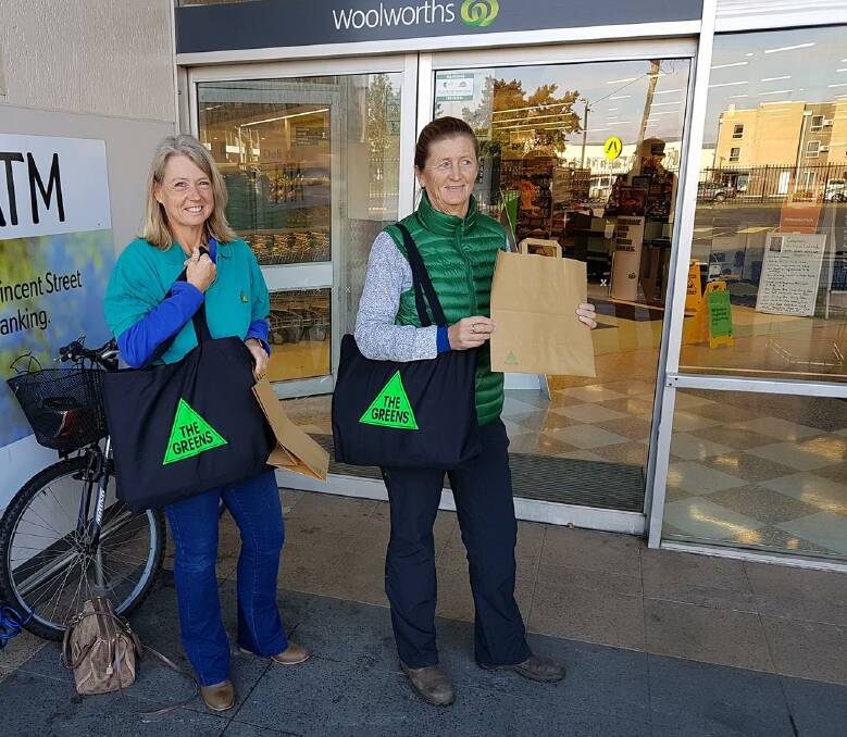 REUSE: Cessnock-Kurri Greens members Cathy Talley and Janet Murray handing out paper bags at Woolworths Cessnock on June 20, the day single-use plastic bags were phased out at the supermarket.