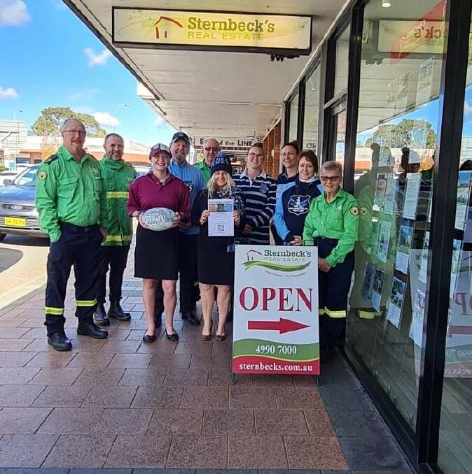 SUPPORT: Cessnock District Rescue Squad volunteers with staff from Sternbeck's Real Estate, who are raffling State of Origin tickets to raise funds for the squad.