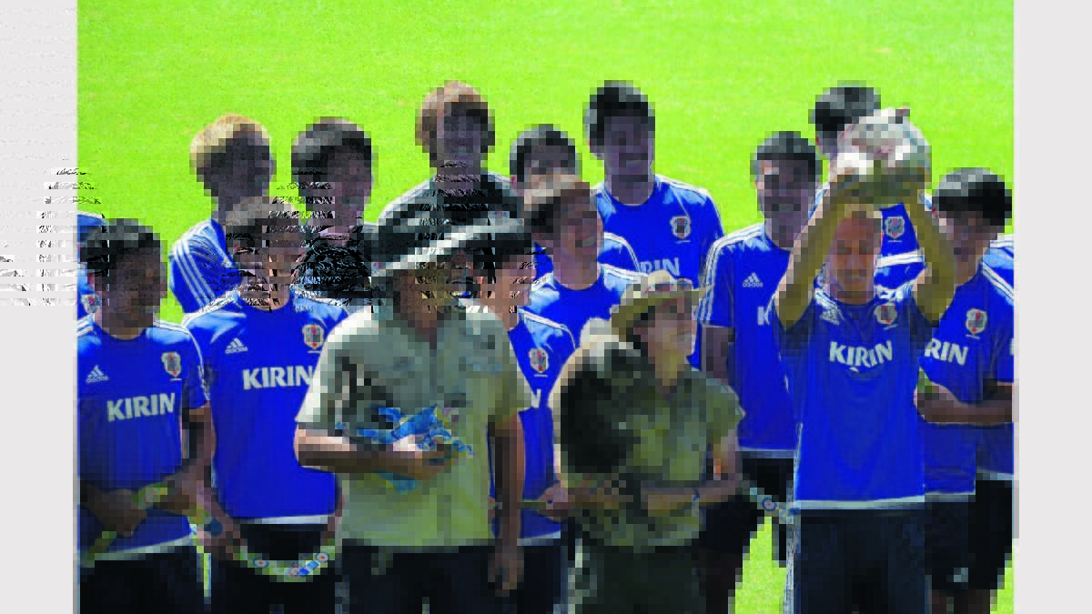 EXCITEMENT: Japanese football star Keisuke Honda holds Ally the Wombat aloft at the football team's farewell function at Cessnock Sportsground on January 8, 2015. Photo by Krystal Sellars, The Advertiser.