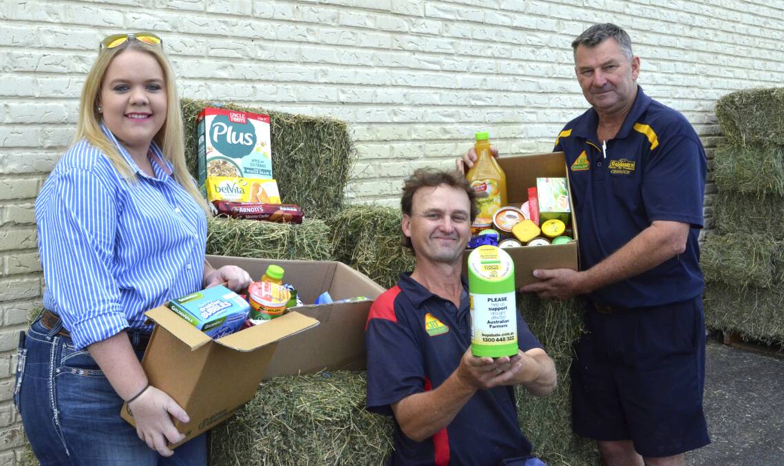 SUPPORT: Mackenzie Pringle and Goldman's Produce staff Chris Conolly and Phillip Goldman with some of the hampers that have been donated to drought-stricken farmers. Picture: Krystal Sellars