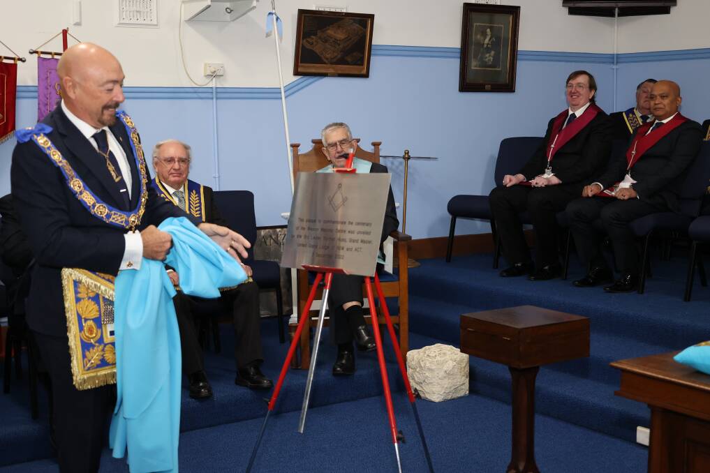 United Grand Lodge of NSW and ACT Grand Master, Most Worshipful Brother Les Hicks unveils the centenary plaque at Weston Masonic Centre on Saturday. Picture by Gregory Allen.