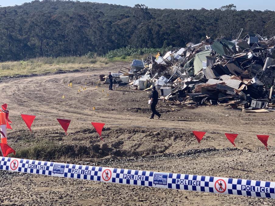 HUNT FOR CLUES: Forensic police survey the scene inside Cessnock Waste Management Centre, where a 54-year-old man suffered fatal injuries on Sunday.
