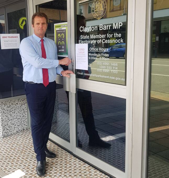 MINIMISING THE SPREAD: Cessnock MP Clayton Barr locks his doors on Friday. His office can still be contacted via phone or email.