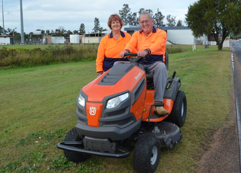 UPGRADE: Weston Heritage and Tidy Town Committee secretary-treasurer Pat Maybury and president Mick Haines with the ride-on mower they bought with funding from the 2017 Community Building Partnerships program.