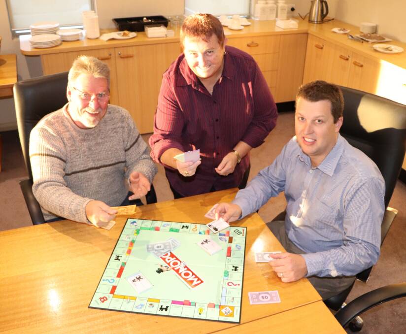 Cessnock's deputy mayor John Moores, Ward C councillor Anne Sander and mayor Jay Suvaal play a game of Monopoly. Picture supplied