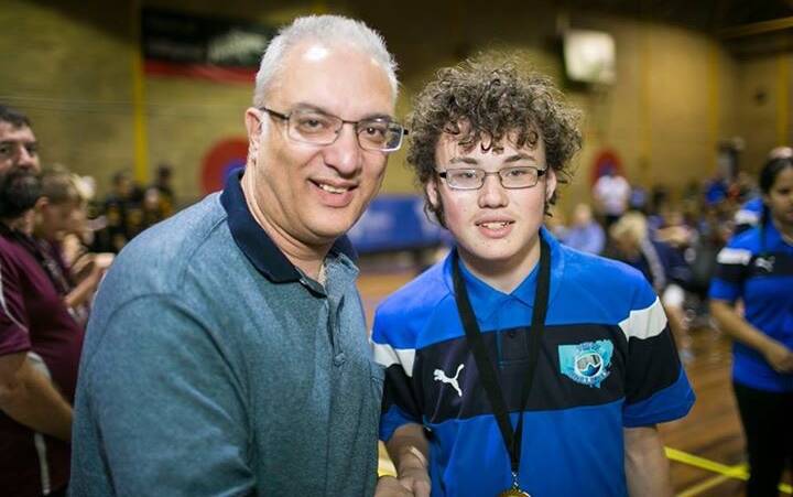 ACHIEVEMENT: Blind Sports Association chair Sam Theodore presents Tyson O'Neil with his gold medal at the national goalball championships. Picture: supplied