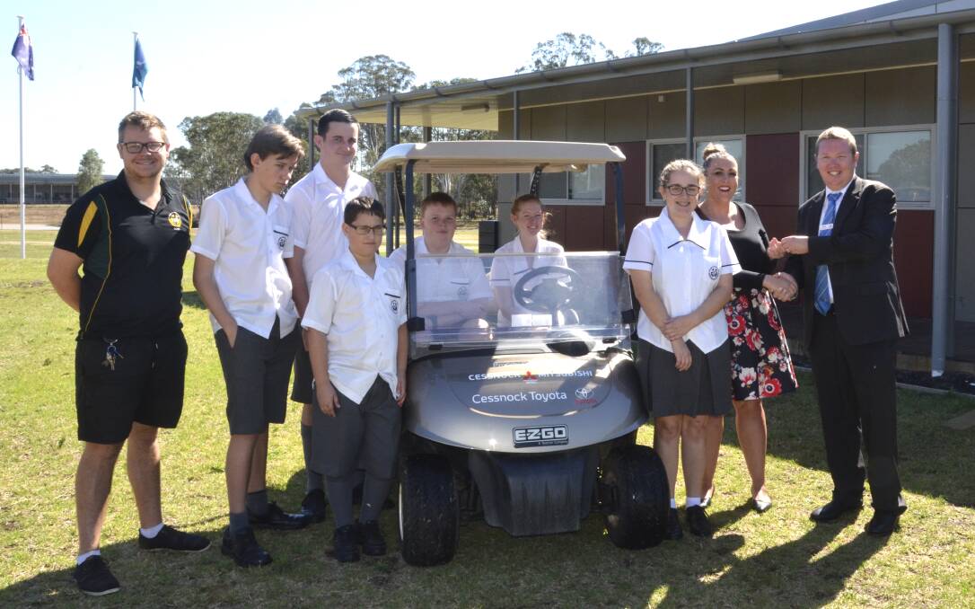 ACCESS: DALE Christian School Cessnock students and staff with Cessnock Mitsubishi general manager Scott Harris and the donated golf cart.
