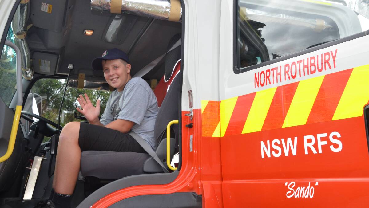 TREAT: Will Stothard gets ready for a ride in the North Rothbury Rural Fire Brigade truck, as a thank you for sharing his Zooper Doopers with the firefighters last month.