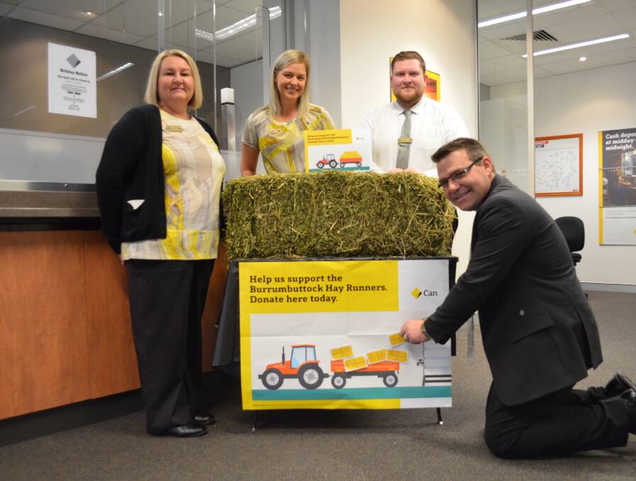 SUPPORT: Commonwealth Bank Cessnock staff Suz Cordowiner, Stephanie Clark, Kane Jackson and Andrew Turner, pictured with the hay bale display where customers can donate to the Burrumbuttock Hay Runners.
