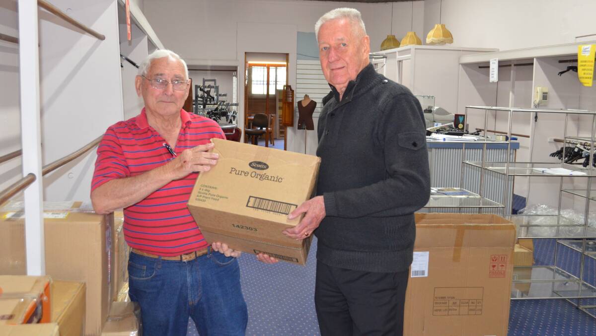 GENEROUS: Les Beveridge (right) hands over a box of stock to Grahame Dunnicliff from Cessnock Lions Club, who will help to organise the delivery of the goods to the Queensland bushfire victims. Picture: Krystal Sellars
