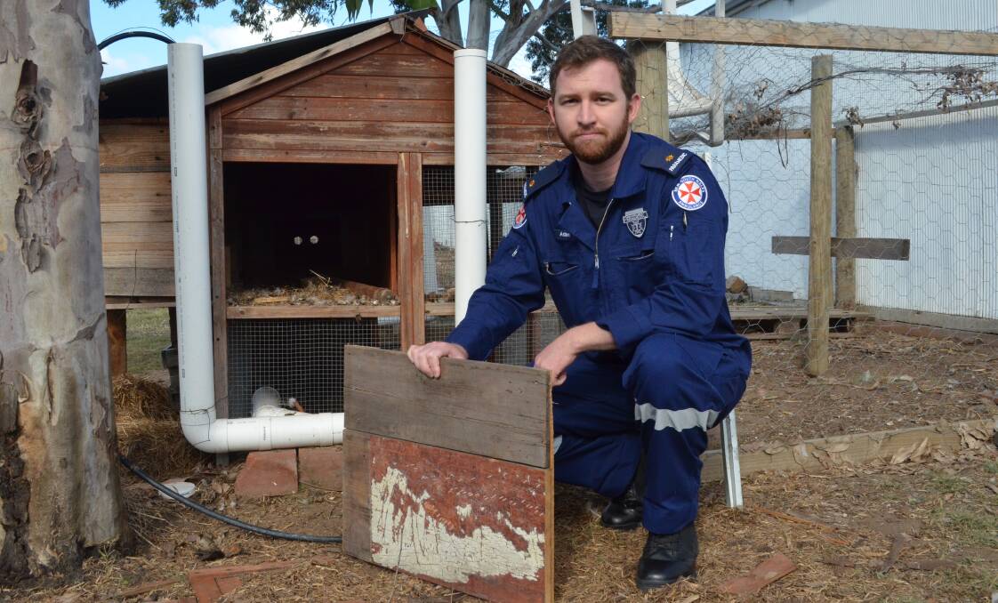 SAD: Cessnock Ambulance Station acting station officer Adam Grieve at the compound where five chickens were stolen on Wednesday night. Picture: Krystal Sellars