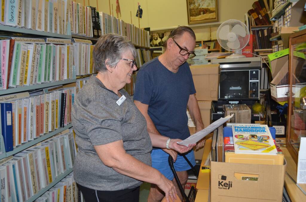 TREASURE TROVE: Museum volunteers Lexie Matthews and Ean Smith look over some of the items that will be moved from Kurri Kurri to the Abermain School of Arts.