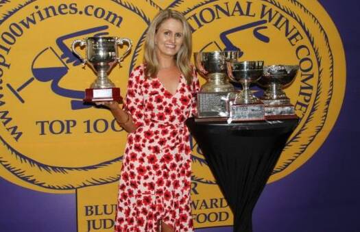 HONOURS: McLeish Estate business operations manager Jessica McLeish with their trophy haul from the Sydney International Wine Competition.